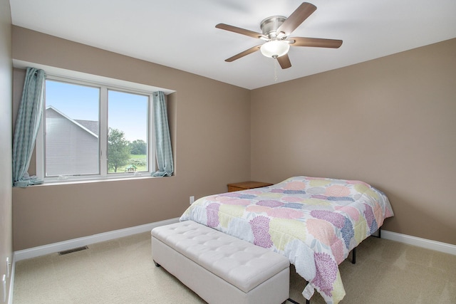 carpeted bedroom with visible vents, ceiling fan, and baseboards