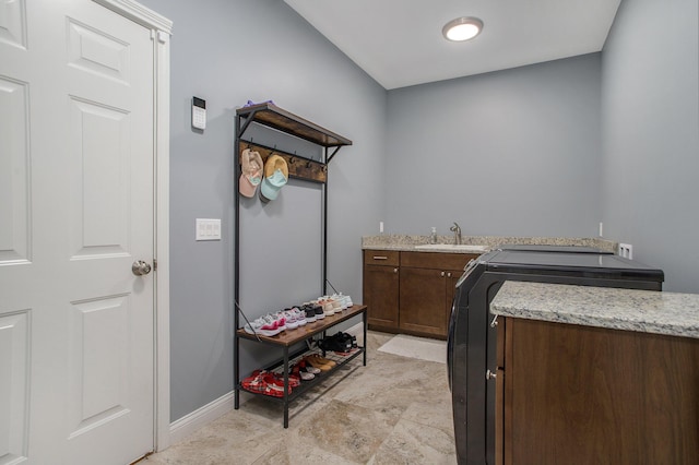 laundry room featuring washer and dryer, cabinet space, and a sink