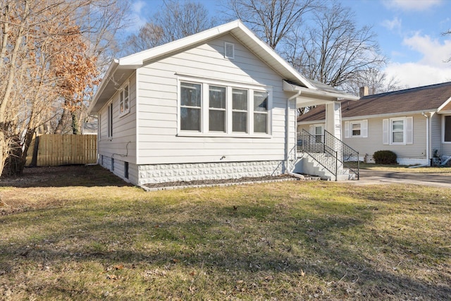 bungalow-style house featuring a front yard and fence