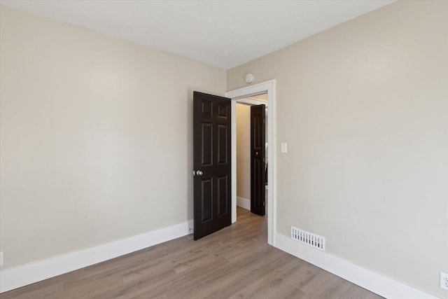 unfurnished room with visible vents, baseboards, and light wood-style floors