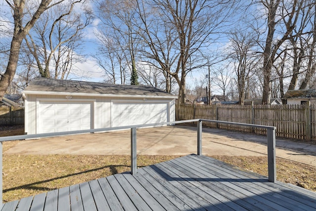 wooden terrace with an outdoor structure, a fenced backyard, and a garage