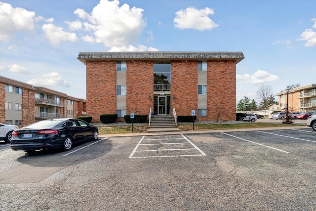 view of building exterior featuring uncovered parking