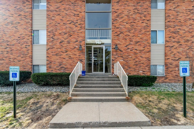 doorway to property with brick siding