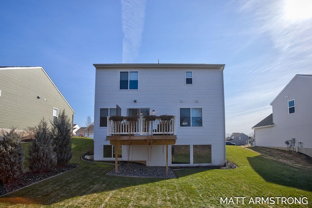 back of house featuring a lawn and a deck