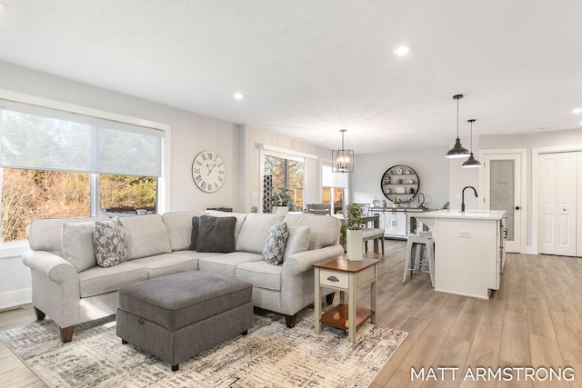 living room with recessed lighting, a healthy amount of sunlight, and light wood-type flooring