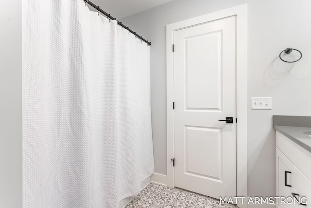 full bath with tile patterned floors and vanity