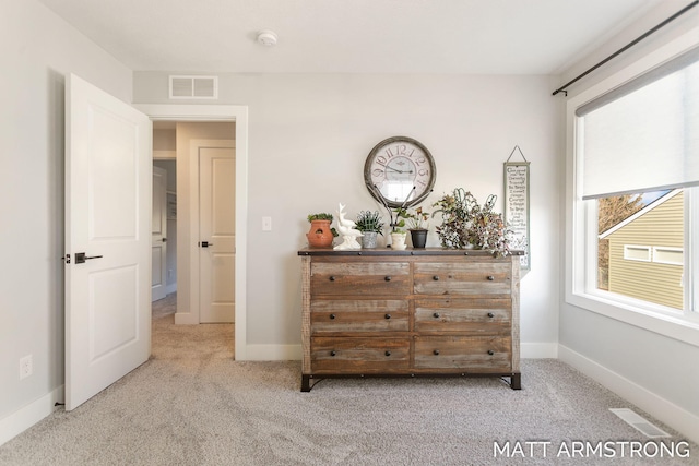 unfurnished bedroom featuring visible vents, baseboards, and carpet floors