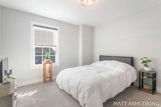 carpeted bedroom featuring baseboards