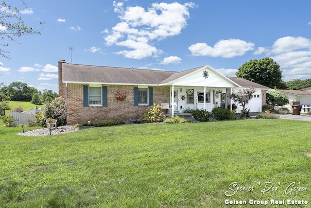 single story home with fence, a chimney, a front lawn, a garage, and brick siding