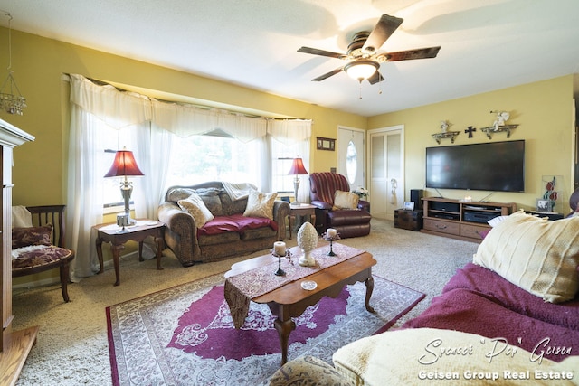 carpeted living room featuring ceiling fan