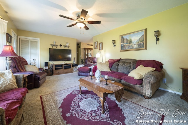 carpeted living area featuring baseboards and ceiling fan