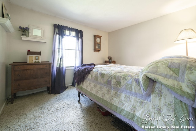 carpeted bedroom featuring baseboards