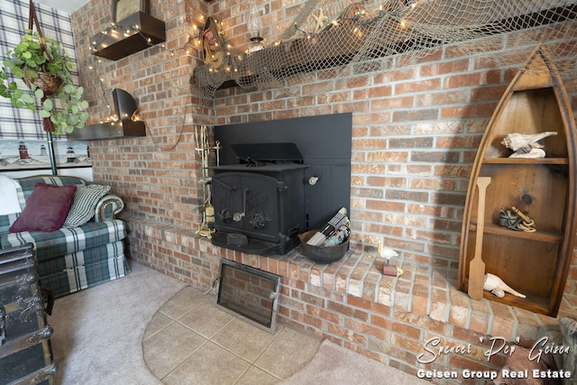 carpeted living area featuring brick wall and a wood stove