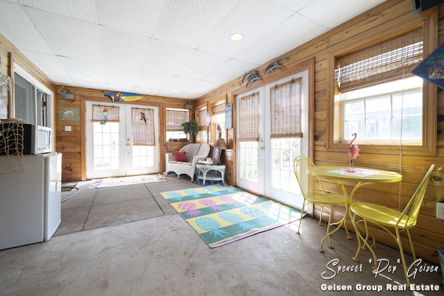 interior space with french doors and a paneled ceiling