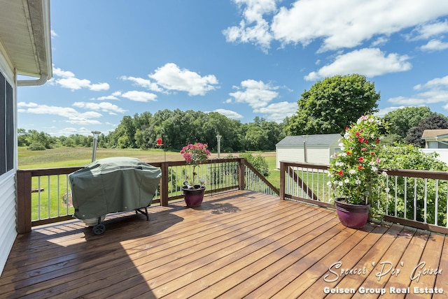 deck with grilling area and a yard