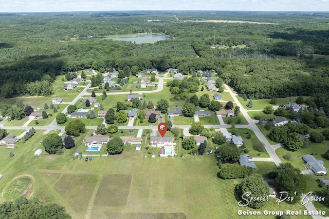 birds eye view of property featuring a water view and a view of trees