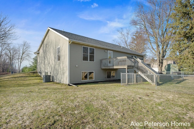 rear view of house with a deck, stairway, central air condition unit, and a yard