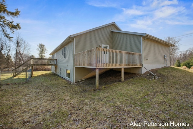 exterior space with a lawn, stairs, and a deck