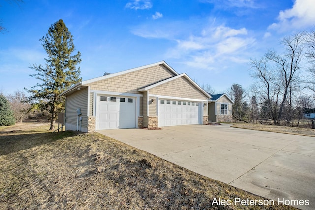 view of side of home featuring stone siding, concrete driveway, and an attached garage