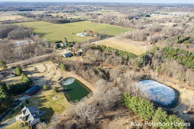 birds eye view of property with a rural view and a water view