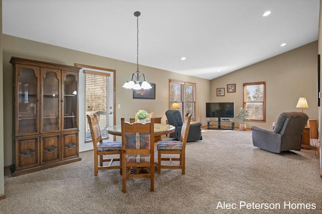 carpeted dining space with recessed lighting, lofted ceiling, and an inviting chandelier