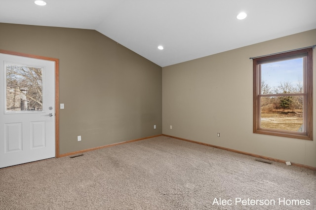 carpeted spare room featuring vaulted ceiling, recessed lighting, baseboards, and visible vents