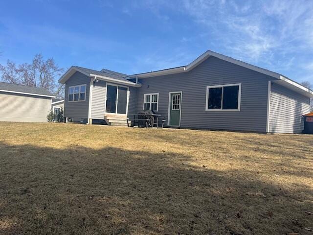 back of house with a lawn