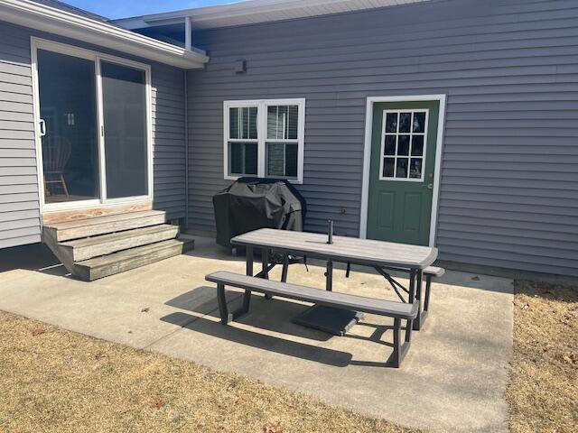 view of patio with entry steps and area for grilling