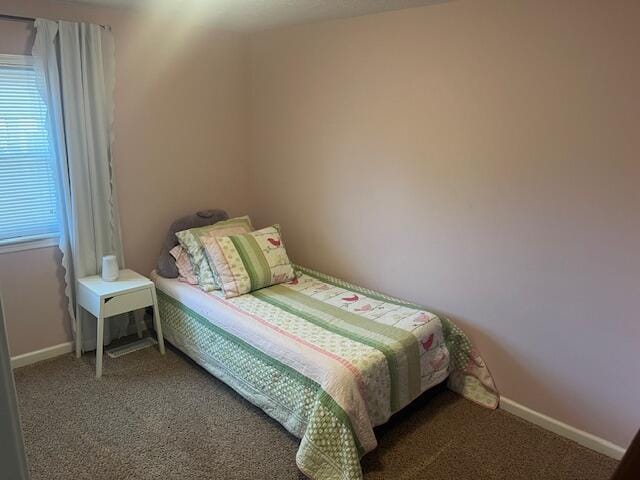 bedroom with baseboards and carpet flooring