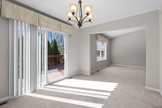 unfurnished room with visible vents, baseboards, light colored carpet, and an inviting chandelier