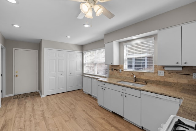 kitchen with ceiling fan, light wood-type flooring, white cabinets, white appliances, and a sink