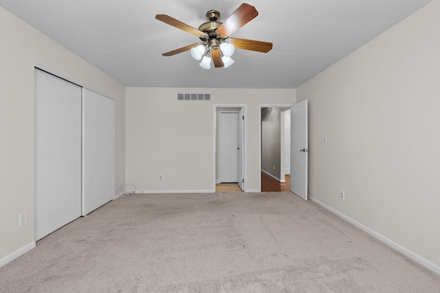 unfurnished bedroom with a ceiling fan, carpet flooring, baseboards, and visible vents