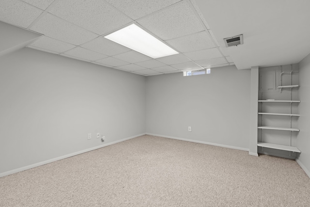 interior space featuring baseboards, visible vents, carpet floors, and a paneled ceiling