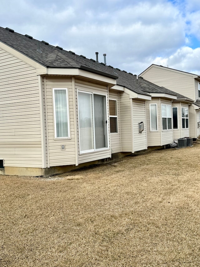 rear view of property with a lawn