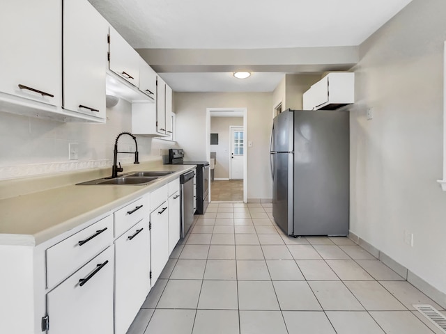 kitchen with visible vents, light countertops, white cabinets, stainless steel appliances, and a sink