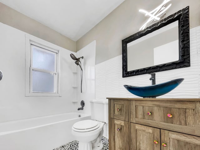 bathroom featuring vanity, tile patterned floors, toilet, and shower / washtub combination