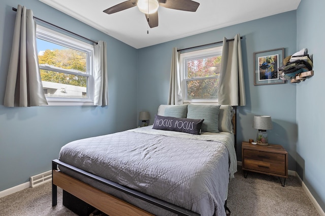 bedroom featuring visible vents, carpet flooring, a ceiling fan, and baseboards