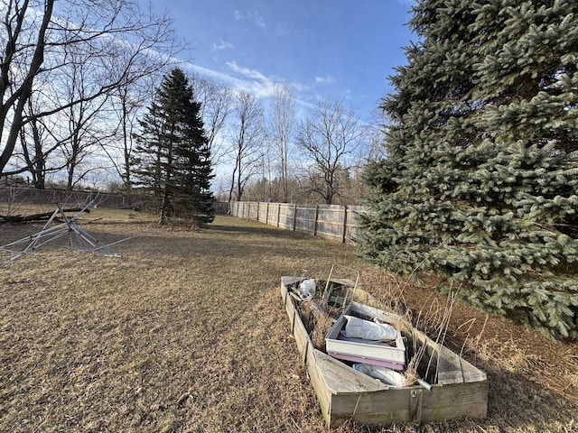 view of yard featuring a vegetable garden and fence