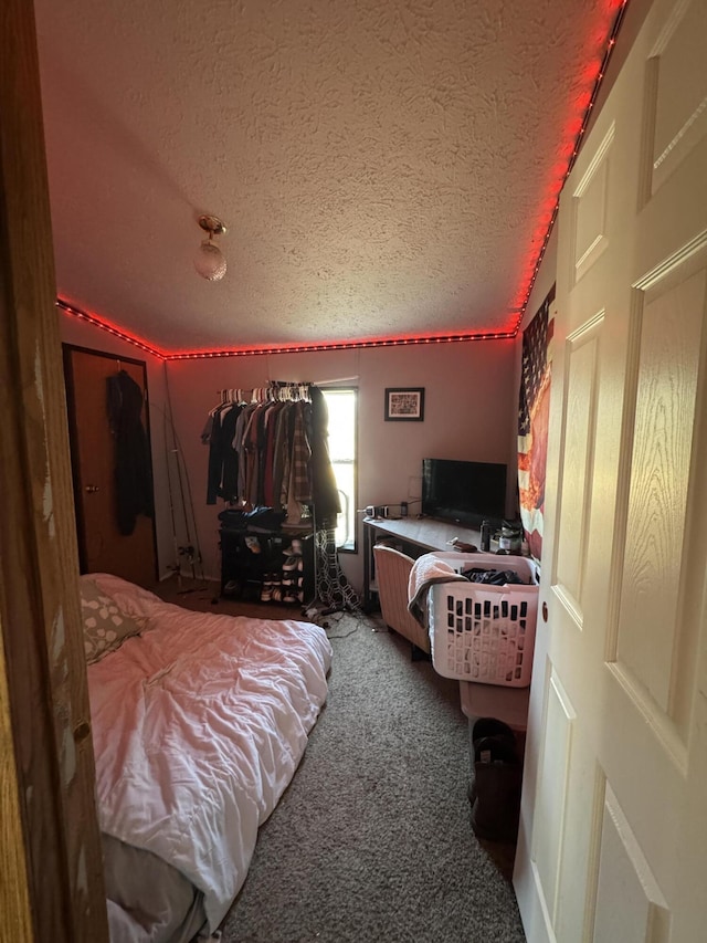 bedroom with carpet flooring and a textured ceiling