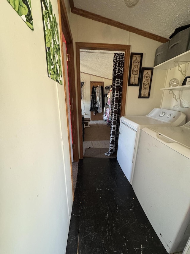 laundry area featuring a textured ceiling, crown molding, laundry area, and washer and clothes dryer