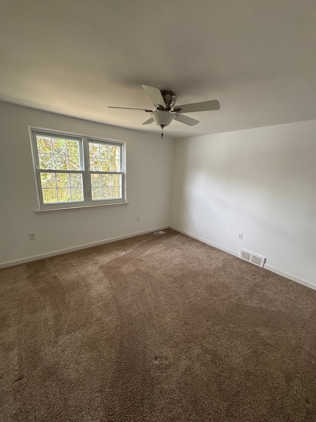 45577 Kensington St, Utica, MI 48317 - spare room featuring dark carpet, ceiling fan, and baseboards