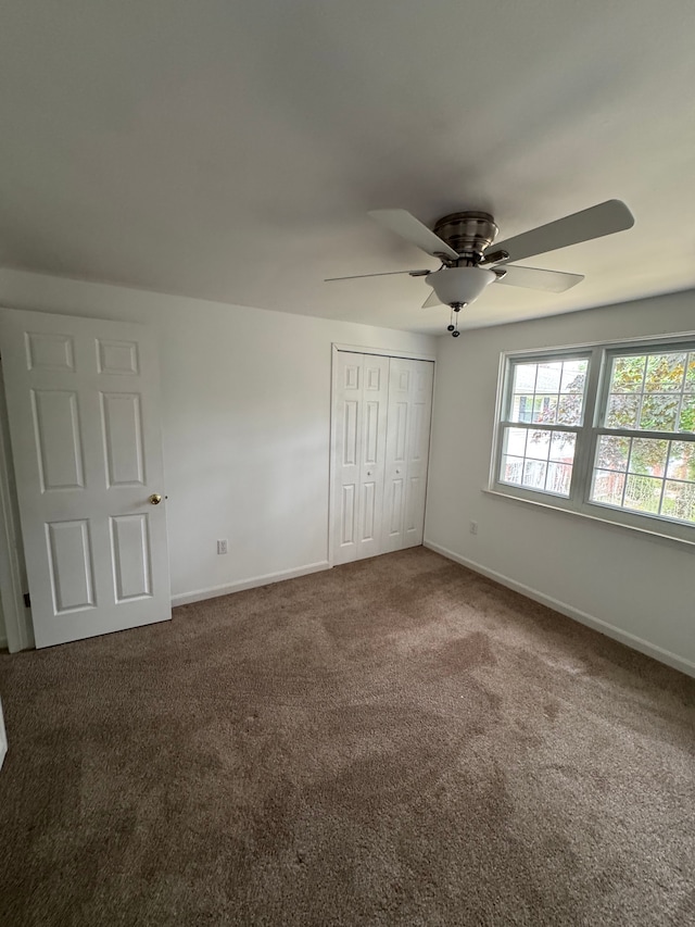 45577 Kensington St, Utica, MI 48317 - unfurnished bedroom featuring carpet floors, baseboards, a closet, and ceiling fan