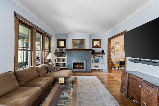 living room featuring dark wood-style floors, a fireplace, and ornamental molding