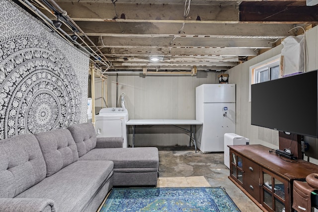 living room with washer / clothes dryer and concrete floors