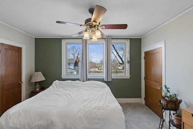 bedroom with a textured ceiling, baseboards, carpet floors, and ornamental molding