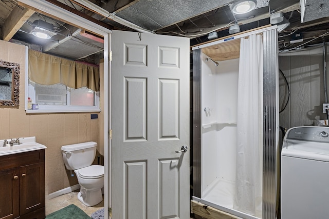 full bath with vanity, toilet, washer / dryer, and a shower stall