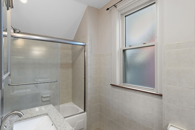 bathroom featuring a sink and enclosed tub / shower combo