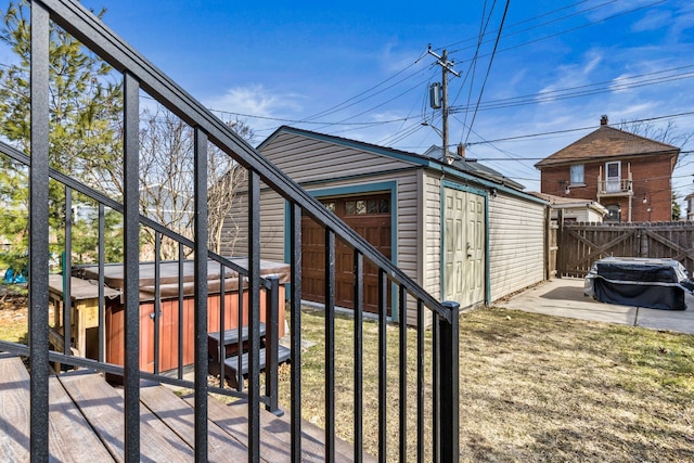 view of side of property with an outdoor structure and fence