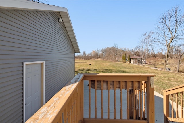 wooden deck featuring a lawn