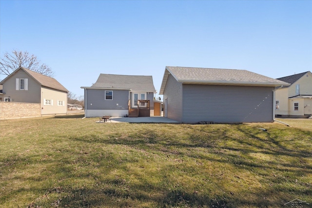 rear view of house with an outbuilding, a yard, and a patio area